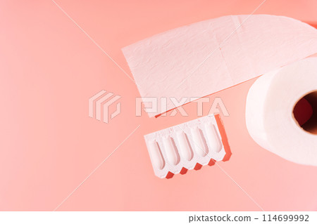 Rectal candles in packaging and toilet paper on a pink background Rectal candles in packaging and toilet paper on a pink background 114699992