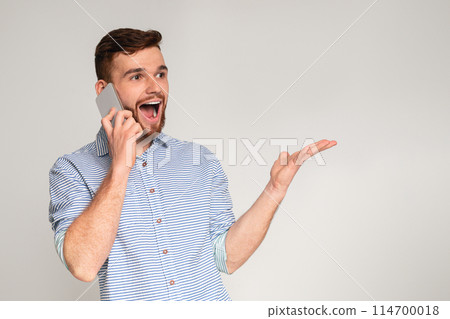Come on. Handsome guy happy to hear good news talking on phone, studio background, panorama Come on. Handsome guy happy to hear good news talking on phone, studio background, panorama 114700018