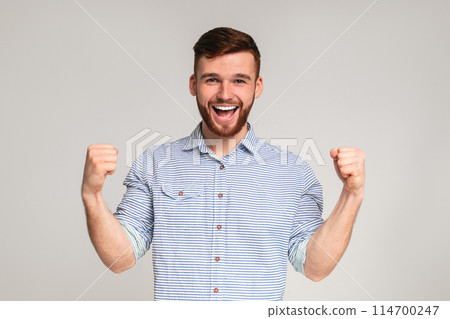 Cheerful guy showing his biceps and smiling on studio background, panorama, copy space Cheerful guy showing his biceps and smiling on studio background, panorama, copy space 114700247