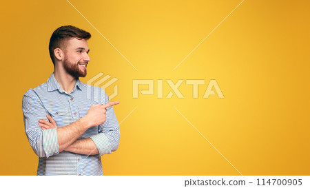 A man with a beard points at something, indicating a direction or highlighting a specific item. 114700905
