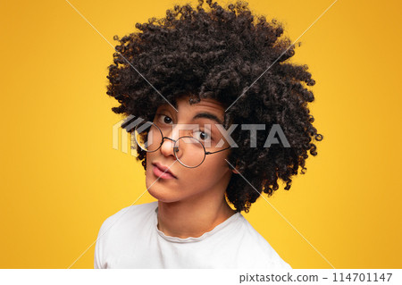 Young black skeptical man looking suspicious, having some doubt, orange panorama background with empty space 114701147