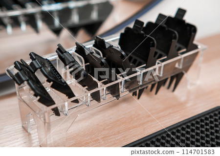 Trimmer attachments on the table in the barbershop. 114701583