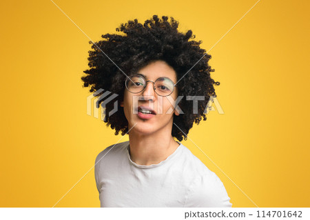 Friendly black bushy guy on orange background, lifestyle portrait 114701642