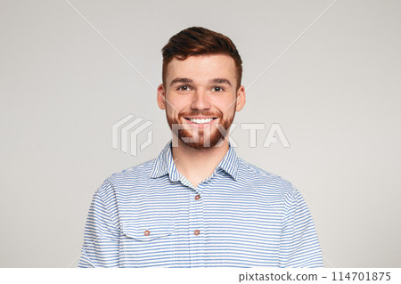 Portrait of smiling millenial guy on beige background, panorama, copy space Portrait of smiling millenial guy on beige background, panorama, copy space 114701875