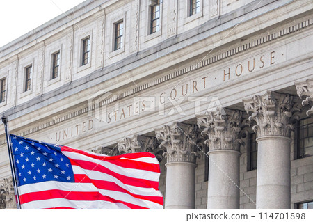 USA national flag waving in the wind in front of United States Court House in New York 114701898