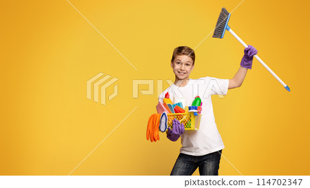 A child, boy holding broom basket toys, playing cleaning helping assisting chore fun responsibility childhood, active, cheerful, indoors, home. A child, boy holding broom basket toys, playing cleaning helping assisting chore fun responsibility childhood, active, cheerful, indoors, home. 114702347