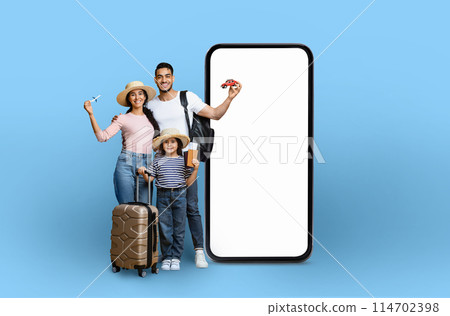 A family with travel gear and a toy car next to a mockup smartphone, illustrating travel planning technology, isolated on a blue background 114702398