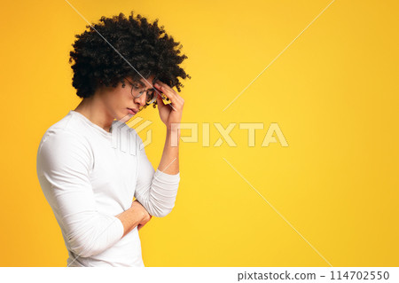 Lack of inspiration. Depressed african man deep in thoughts, touching his forehead, orange panorama background with empty space Lack of inspiration. Depressed african man deep in thoughts, touching his forehead, orange panorama background with empty space 114702550