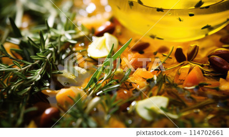 Fresh aromatic olive oil with lemon, rosemary, spices, Mediterranean food background 114702661