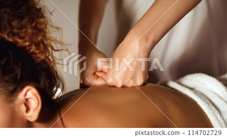 A skillful deep tissue massage is administered to an African American woman, illustrating the spa's commitment to deep relaxation A skillful deep tissue massage is administered to an African American woman, illustrating the spa's commitment to deep relaxation 114702729