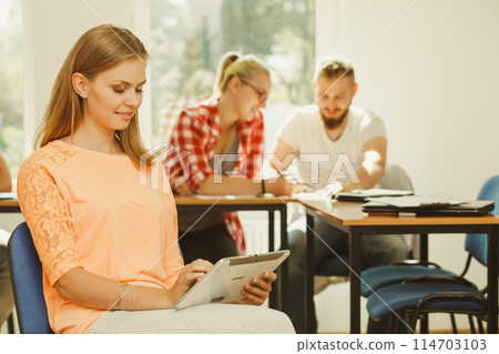 Student girl with tablet in front of her classmates 114703103