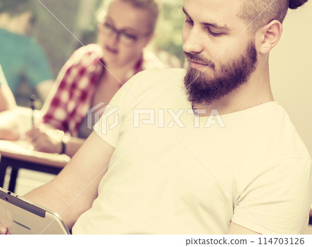 Student boy with tablet in front of her classmates Student boy with tablet in front of her classmates 114703126