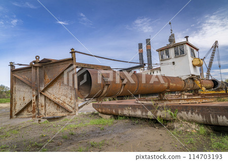 detail of old, rusty, river dredge on a shore of Missouri River in Nebraska 114703193