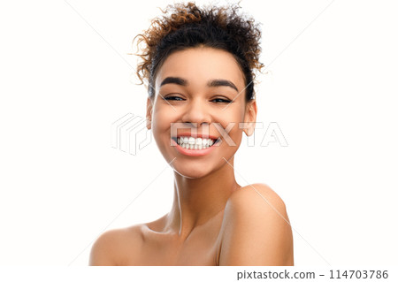 A close-up photograph of a young african american woman with a beaming smile, exuding warmth, confidence, and happiness, isolated on a white background A close-up photograph of a young african american woman with a beaming smile, exuding warmth, confidence, and happiness, isolated on a white background 114703786