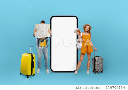 Travelers man and woman with map and luggage by a blank smartphone screen, illustrating travel planning and digital technology applications 114704134