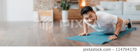 Strong asian mature man making strength workout, standing in plank pose or doing push ups at home on yoga mat. Happy guy training his body, leading active lifestyle, copy space Strong asian mature man making strength workout, standing in plank pose or doing push ups at home on yoga mat. Happy guy training his body, leading active lifestyle, copy space 114704170