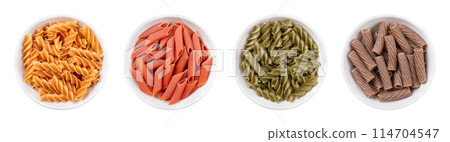 Gluten-free pasta variants in white bowls. Four different types of noodles made without wheat flour. From left to right chickpea fusilli, red lentil penne, green pea fusilli and buckwheat tortiglioni. 114704547