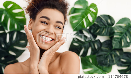 African-american girl with perfect skin over background with tropical leaves African-american girl with perfect skin over background with tropical leaves 114704678