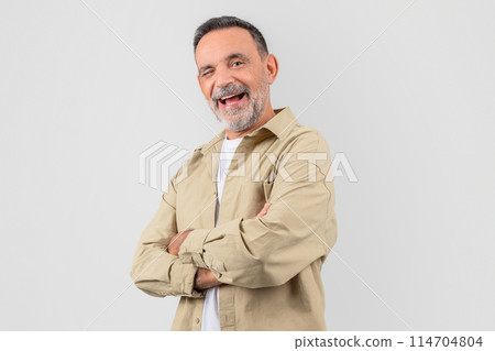 Old man with a warm smile, arms confidently crossed in front of him, isolated on a white background, exudes friendliness Old man with a warm smile, arms confidently crossed in front of him, isolated on a white background, exudes friendliness 114704804