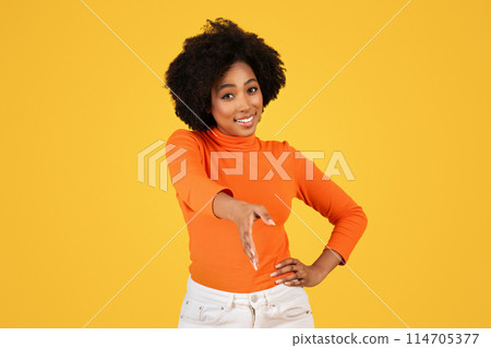 Smiling woman with curly hair in orange turtleneck offering a handshake, portraying a friendly and professional gesture, paired with white pants, on a cheerful yellow background Smiling woman with curly hair in orange turtleneck offering a handshake, portraying a friendly and professional gesture, paired with white pants, on a cheerful yellow background 114705377