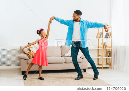 African-american father dancing with little daughter at home African-american father dancing with little daughter at home 114706020
