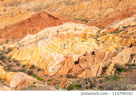 landscape of Skazka canyon on Issyk-Kul lake. Rocks Fairy Tale famous destination in Kyrgyzstan. Mountain like great wall of china and Rainbow Mountains of Danxia or Antelope crevice USA, Central Asia landscape of Skazka canyon on Issyk-Kul lake. Rocks Fairy Tale famous destination in Kyrgyzstan. Mountain like great wall of china and Rainbow Mountains of Danxia or Antelope crevice USA, Central Asia 114706592