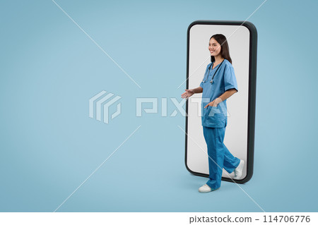 Young European lady in medical uniform steps off giant smartphone screen and greets someone, showcasing telemedicine's reach on blue backdrop, free space 114706776
