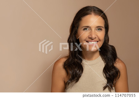 Positive caucasian senior woman with natural makeup, enjoy anti-wrinkle treatment, skin care, isolated on beige studio background. Beauty care, spa procedures, lifestyle, moistening Positive caucasian senior woman with natural makeup, enjoy anti-wrinkle treatment, skin care, isolated on beige studio background. Beauty care, spa procedures, lifestyle, moistening 114707055