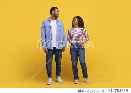 African American couple standing next to each other, facing forward. Both individuals appear to be looking straight ahead, with a neutral expression 114708259