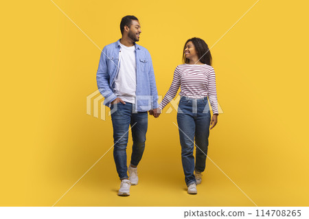 African American man and woman are holding hands, showcasing a gesture of unity, love, and connection, symbolizing support and intimacy between them. African American man and woman are holding hands, showcasing a gesture of unity, love, and connection, symbolizing support and intimacy between them. 114708265