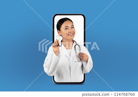 This image shows a young asian woman doctor on a smartphone screen, delivering innovative telehealth services from a neat, professional office. 114708760