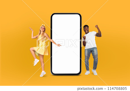 Multiracial couple standing next to huge telephone. They appear to be engaged in conversation, possibly discussing the call, yellow background, mockup copy space Multiracial couple standing next to huge telephone. They appear to be engaged in conversation, possibly discussing the call, yellow background, mockup copy space 114708805