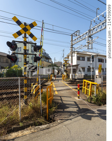 A small railroad crossing in an urban area 114709099