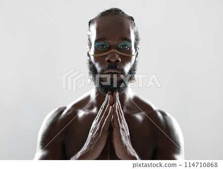 Serious black gay man with makeup joining hands in Serious black gay man with makeup joining hands in 114710868
