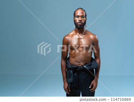 Shirtless muscular black gay man with light makeup Shirtless muscular black gay man with light makeup 114710869
