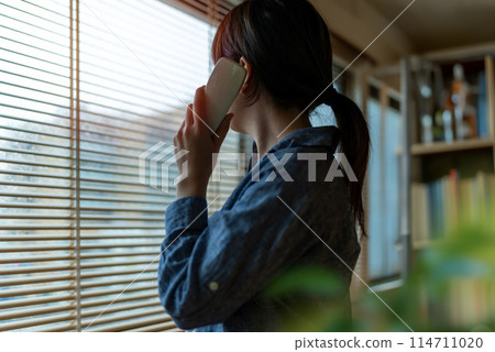 A woman making a phone call A woman making a phone call 114711020