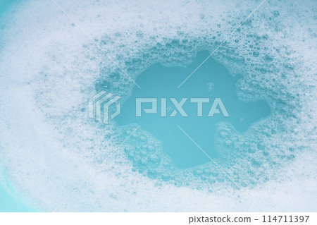 Detergent foam bubble on water. Blue background, Soap sud Detergent foam bubble on water. Blue background, Soap sud 114711397