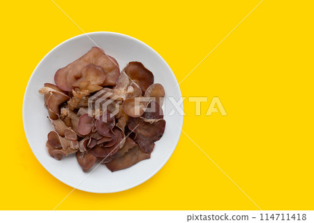 Black fungus mushroom on yellow background. 114711418