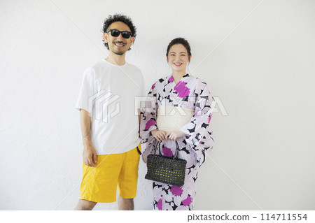 一個穿著浴衣的女人和一個戴著墨鏡的男人 一個穿著浴衣的女人和一個戴著墨鏡的男人 114711554