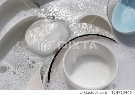 Dishes and bowls in water and bubbles of dishwashing liquid. Kitchen work 114713446