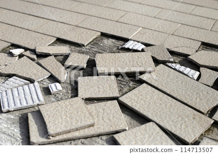 Cracked brown tiles on cement floor Cracked brown tiles on cement floor 114713507