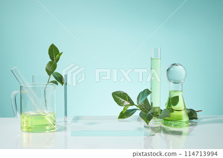 Photo was taken from front view on baby blue background with gradient effect, an empty platform placed in center with some researching tools and green tea decorated around, presentation space Photo was taken from front view on baby blue background with gradient effect, an empty platform placed in center with some researching tools and green tea decorated around, presentation space 114713994