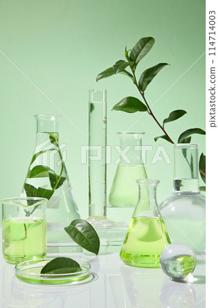 Many different experimental tools are neatly arranged on a white table that stands out against the green background. Photo was shot from front with vacant space for design Many different experimental tools are neatly arranged on a white table that stands out against the green background. Photo was shot from front with vacant space for design 114714003
