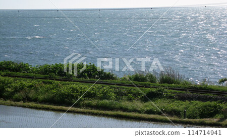 Rice fields, railway and the Sea of Japan 114714941