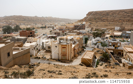 Sun-drenched Ghomrassen cityscape with modern and ancient buildings Sun-drenched Ghomrassen cityscape with modern and ancient buildings 114715938