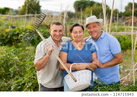 Photo of cheerful family in garden 114715943
