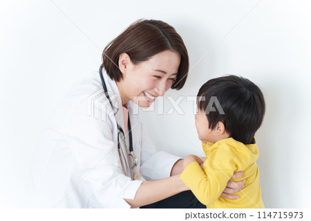 A female pediatrician comforting a child 114715973