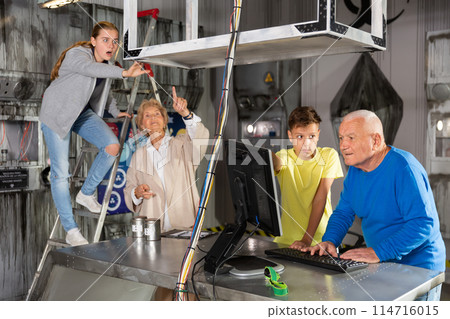 Grandparents and grandkids solving conundrums in escape room Grandparents and grandkids solving conundrums in escape room 114716015