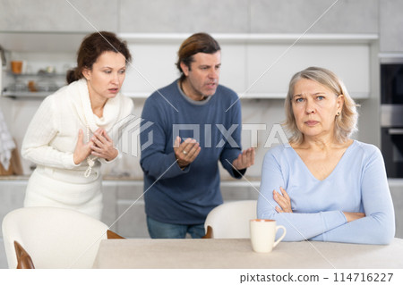 Adult children man and woman clashed with elderly mother. 114716227