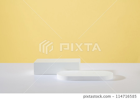 Minimal scene concept with two podiums in different geometric shapes featured over yellow background. Pastel minimal wall scene collection. Modern platform for product display presentation 114716585